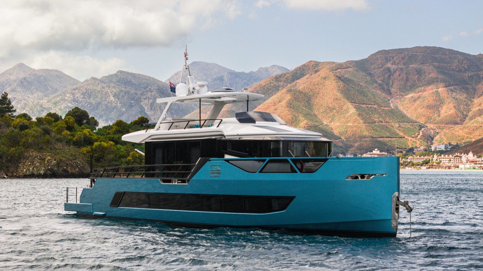 Sarp 85 motor yacht cruising along a mountainous coastline